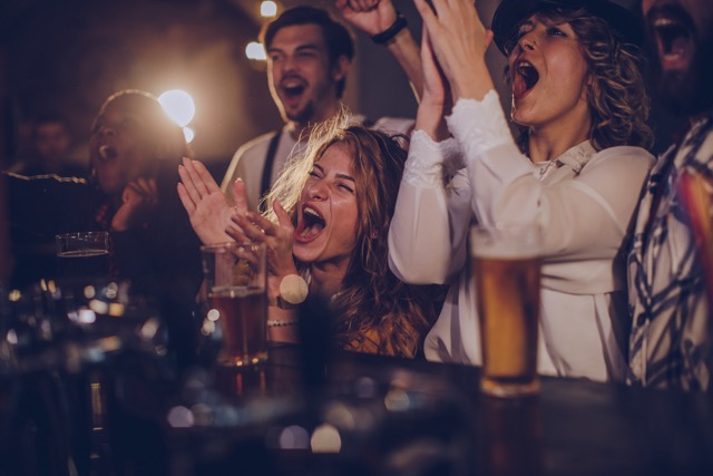 Fans watching a soccer match at a bar or public watch spot