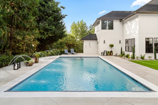 Luxury home swimming pool and patio in a landscaped backyard